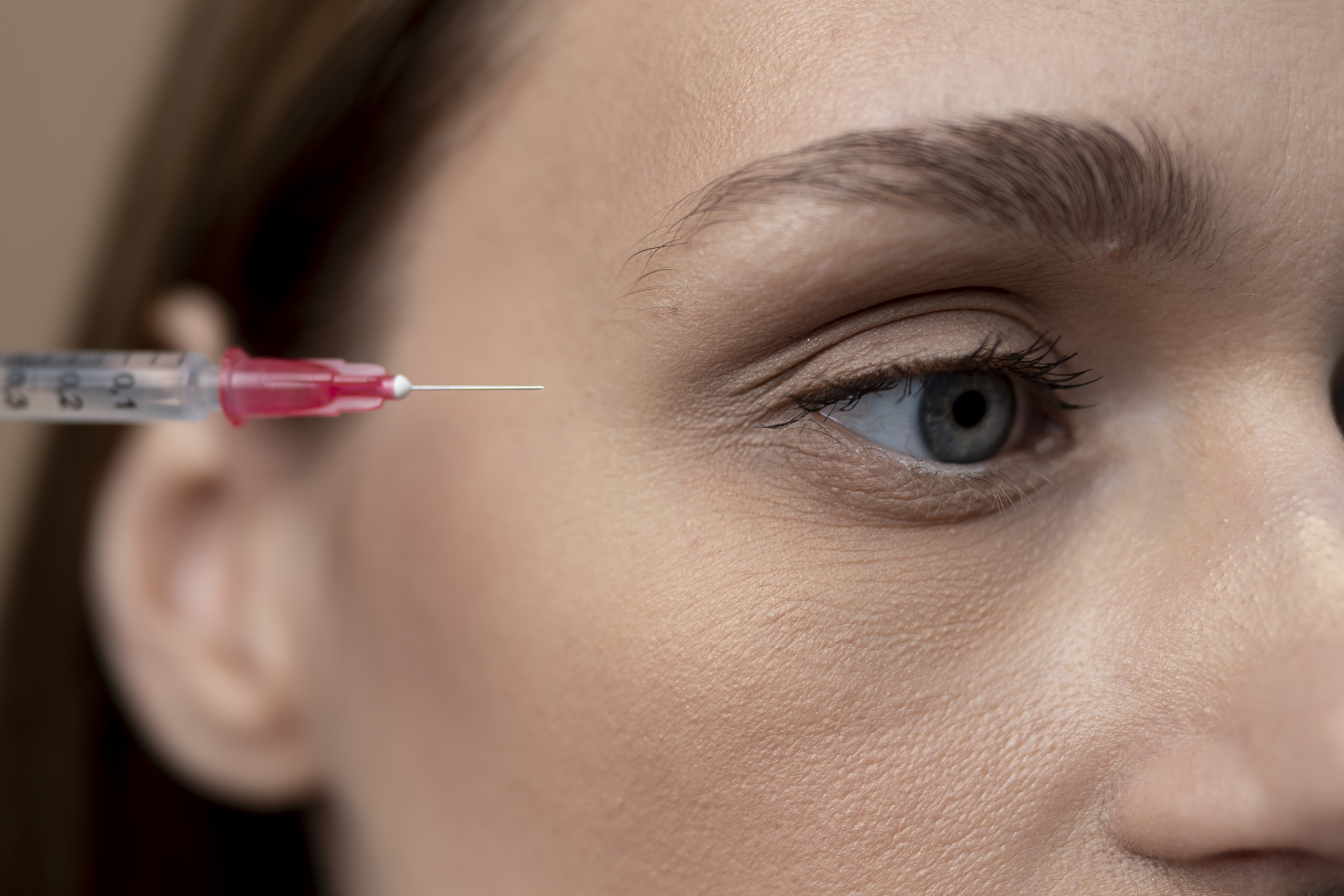 a cosmetologist doctor makes injections with a syringe with a sm